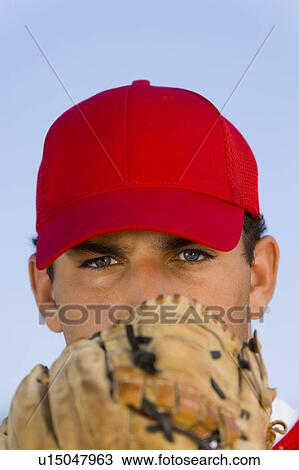 Baseball pitcher holding glove in front of face, (close-up), (portrait) View Large Photo Image Stock Image - Baseball pitcher holding glove in front of face, (close-up), (portrait). Fotosearch