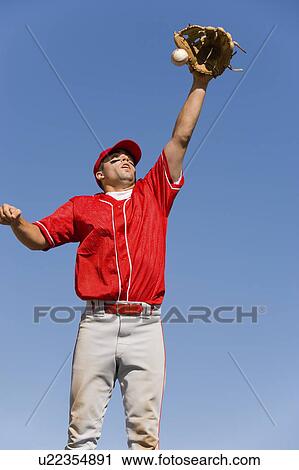 Baseball player catching ball in baseball glove View Large Photo Image Stock Image - Baseball player catching ball in baseball glove. Fotosearch