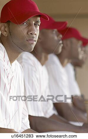 Baseball player sitting with team in dugout, (portrait) View Large Photo Image Stock Image - Baseball player sitting with team in dugout, (portrait). Fotosearch