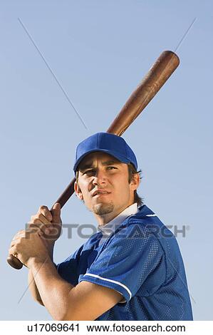 Baseball player swinging baseball bat, (low angle view) View Large Photo Image Stock Image - Baseball player swinging baseball bat, (low angle view). Fotosearch