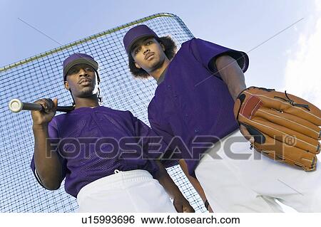 Baseball players wearing uniform, (portrait) View Large Photo Image Stock Photograph - Baseball players wearing uniform, (portrait). Fotosearch