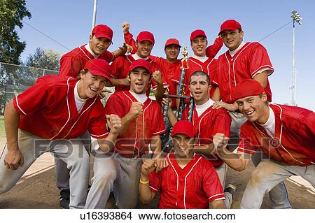 Baseball team-mates holding trophy on field View Large Photo Image Picture - Baseball team-mates holding trophy on field. Fotosearch