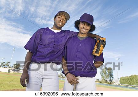 Baseball team mates standing on field, (portrait) View Large Photo Image Stock Photograph - Baseball team mates standing on field, (portrait). Fotosearch