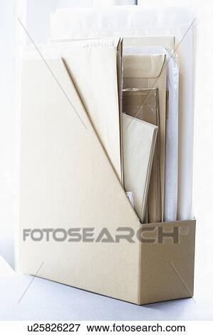 Stock Photo - Box file filled with papers and envelopes. Fotosearch
