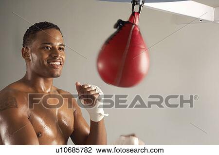 Boxer hitting punching bag, head and shoulders View Large Photo Image Stock Image - Boxer hitting punching bag, head and shoulders. Fotosearch