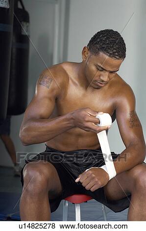 Boxer wrapping his hands in gym View Large Photo Image Stock Photo - Boxer wrapping his hands in gym. Fotosearch
