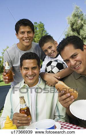 Boy (13-15) with brothers and father at outdoor picnic, portrait View Large Photo Image Stock Photo - Boy (13-15) with brothers and father at outdoor picnic, portrait. Fotosearch