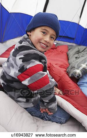 Boy (7-9) in tent, (portrait) View Large Photo Image Stock Photo - Boy (7-9) in tent, (portrait). Fotosearch