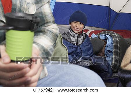 Boy (7-9) with family in tent, (portrait) View Large Photo Image Stock Image - Boy (7-9) with family in tent, (portrait). Fotosearch