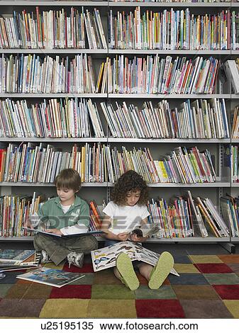 Stock Photography - Boy and girl sitting on library floor reading books. Fotosearch