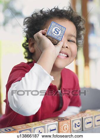 Stock Photo - Boy playing with alphabet blocks, portrait. Fotosearch