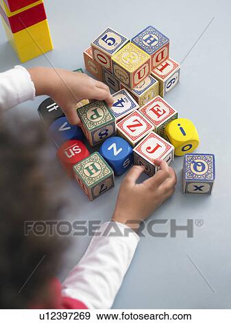 Boy playing with building blocks in classroom, view from above View Large Photo Image Stock Photo - Boy playing with building blocks in classroom, view from above. Fotosearch