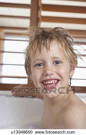 Stock Image - Boy with messy, wet hair, in Bathtub, close-up. Fotosearch