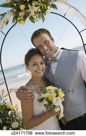 Bride and Groom under archway on beach, (portrait) View Large Photo Image Stock Photo - Bride and Groom under archway on beach, (portrait). Fotosearch
