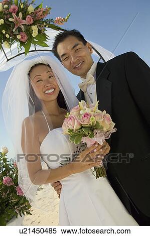 Bride and Groom under archway, (portrait) View Large Photo Image Stock Photography - Bride and Groom under archway, (portrait). Fotosearch