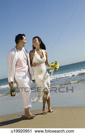 Bride and Groom walking on beach View Large Photo Image Stock Image - Bride and Groom walking on beach. Fotosearch