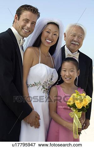 Stock Photo - Bride and Groom with father and sister, outdoors, (portrait). Fotosearch