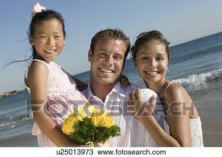 Bride and Groom with flower girl at beach, (portrait) View Large Photo Image Stock Image - Bride and Groom with flower girl at beach, (portrait). Fotosearch