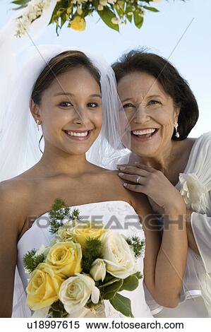 Stock Photography - Bride and mother with bouquet, outdoors, (portrait). Fotosearch
