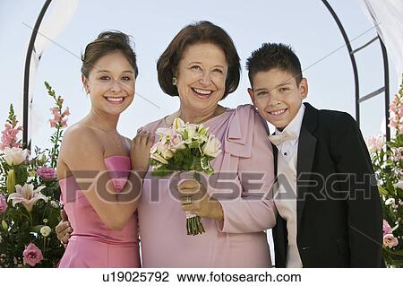 Bride with mother and brother, outdoors, (portrait) View Large Photo Image Stock Image - Bride with mother and brother, outdoors, (portrait). Fotosearch