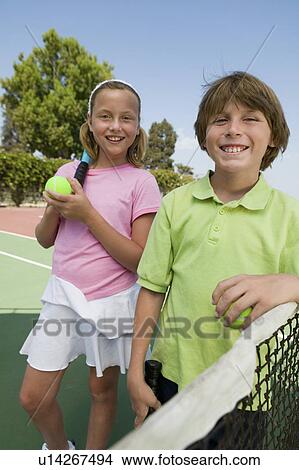 Brother and Sister at Tennis Net, portrait View Large Photo Image Picture - Brother and Sister at Tennis Net, portrait. Fotosearch