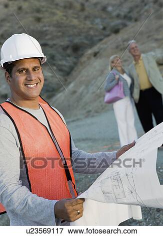 Builder with blueprint for new home, portrait View Large Photo Image Stock Photo - Builder with blueprint for new home, portrait. Fotosearch