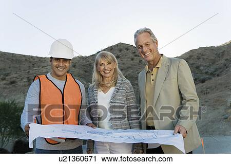 Builder with couple and blueprint for new home, portrait View Large Photo Image Stock Image - Builder with couple and blueprint for new home, portrait. Fotosearch