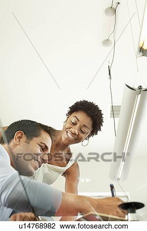 Business colleagues working in office View Large Photo Image Stock Image - Business colleagues working in office. Fotosearch