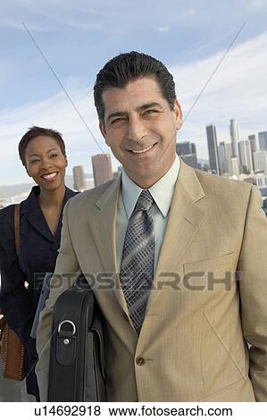 Business people smiling in city View Large Photo Image Stock Photo - Business people smiling in city. Fotosearch
