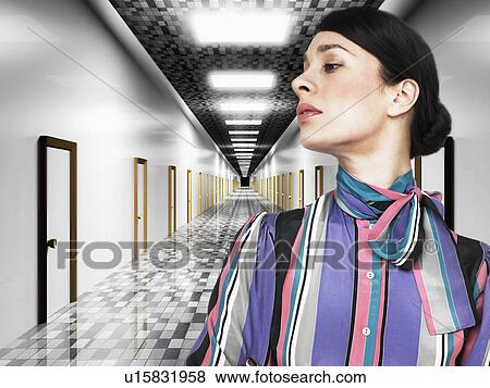 Stock Photo - Business woman in front of digital corridor. Fotosearch