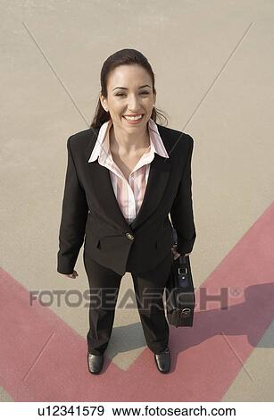 Business woman standing in parking lot View Large Photo Image Stock Photo - Business woman standing in parking lot. Fotosearch
