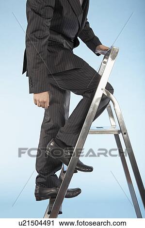Stock Image - Businessman ascending corporate ladder. Fotosearch