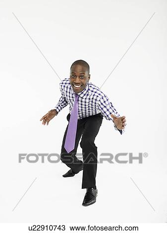 Stock Image - Businessman bending forward in studio. Fotosearch