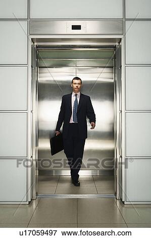 Stock Photo - Businessman Exiting Elevator, front view. Fotosearch