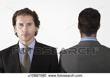 Businessman facing forward, on white background, portrait View Large Photo Image Stock Image - Businessman facing forward, on white background, portrait. Fotosearch
