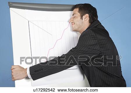 Stock Image - Businessman hugging line graph showing success. Fotosearch
