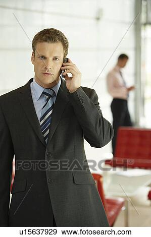 Businessman in Office Using Cell Phone View Large Photo Image Stock Photo - Businessman in Office Using Cell Phone. Fotosearch