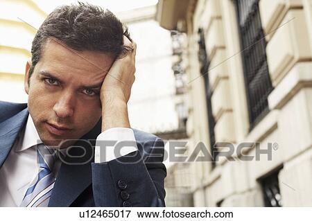 Stock Photo - Businessman outside building, close-up portrait.. Fotosearch