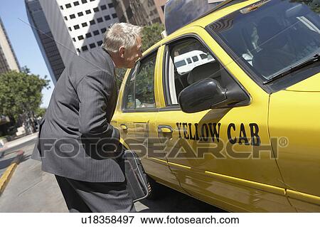 Businessman talking to taxi driver View Large Photo Image Stock Photo - Businessman talking to taxi driver. Fotosearch