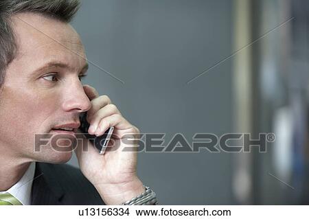 Businessman using cell phone, portrait View Large Photo Image Picture - Businessman using cell phone, portrait. Fotosearch