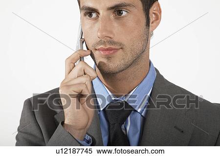 Stock Photography - Businessman using mobile phone, close-up. Fotosearch