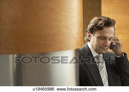 Stock Photograph - Businessman Using mobile phone.. Fotosearch