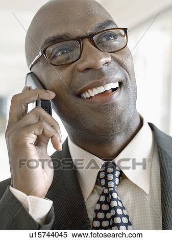 Businessman using mobile phone, indoors, (close-up) View Large Photo Image Stock Photography - Businessman using mobile phone, indoors, (close-up). Fotosearch