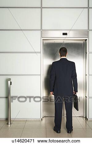 Businessman Waiting for Elevator, rear view View Large Photo Image Stock Image - Businessman Waiting for Elevator, rear view. Fotosearch