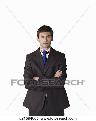 Stock Photography - Businessman with arms crossed, on white background, portrait. Fotosearch