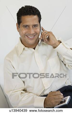 Businessman With PDA and Cell Phone, portrait View Large Photo Image Stock Photo - Businessman With PDA and Cell Phone, portrait. Fotosearch