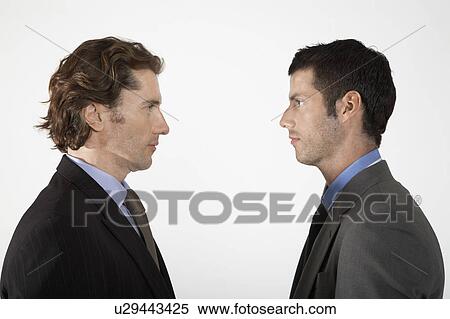 Stock Photography - Businessmen face to face, on white background. Fotosearch