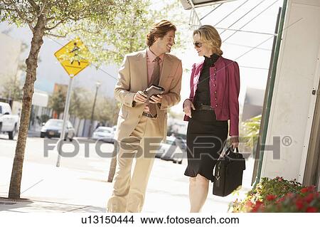 Businesspeople walking in street View Large Photo Image Picture - Businesspeople walking in street. Fotosearch