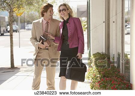 Stock Image - Businesspeople walking in street. Fotosearch