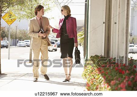 Stock Photo - Businesspeople walking in street. Fotosearch